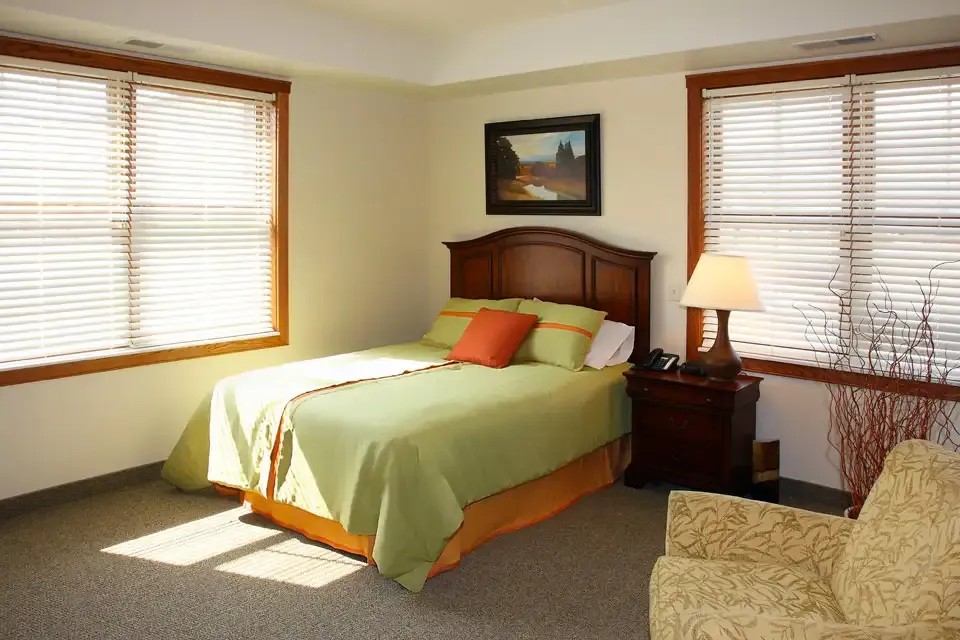 A furnished bedroom in a resident suite at The Alton